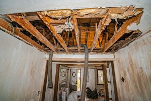 A room undergoing ceiling repair due to fire damage cleanup and restoration.